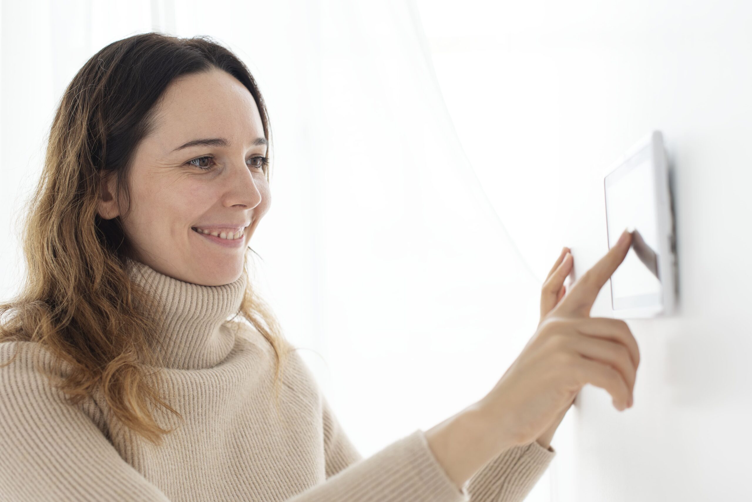 woman-pressing-on-smart-home-automation-panel-monitor